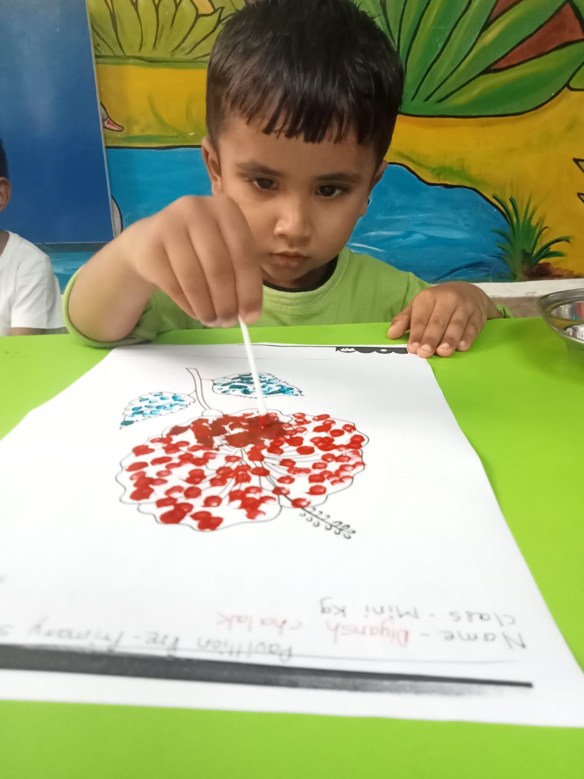Preschool children engaged in a creative art session using colors and paper cutouts